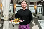 Szef kuchni restauracji Meridian Molo Przemysław Glesner prezentuje  danie z pieczonego halibuta. 