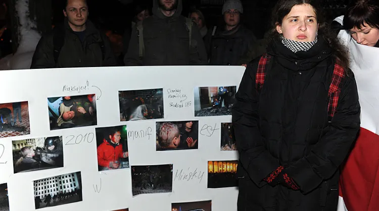 Jedna ze studentek podczas protestu pod konsulatem Białorusi w Gdańsku na tle zdjęć pobitych kolegów, którzy w Mińsku protestowali przeciw wyborowi na prezydenta Łukaszenki.