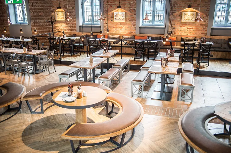 Wnętrze restauracji. Odnowione mury stanowią tu ważny element budowania nastroju wnętrza.