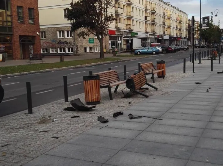 Zniszczona ławka i śmietnik po uderzeniu samochodu na ul. Rajskiej w Gdańsku.