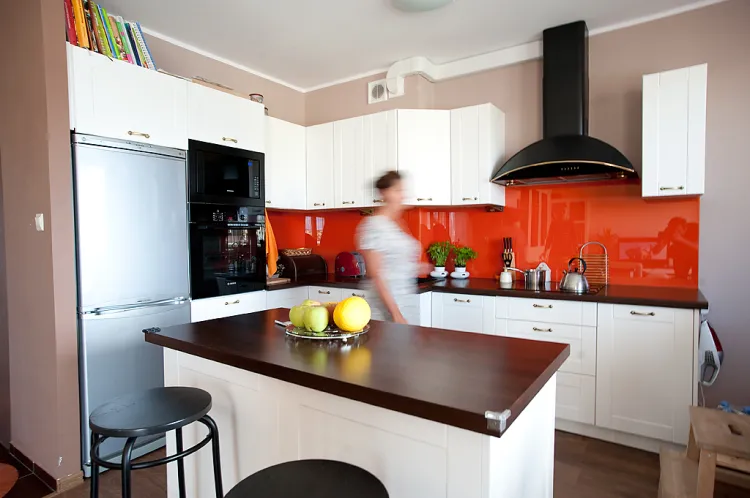 Kuchnia otwarta. Wizualną barierę oddzielającą strefę gotowania od salonu stanowi kuchenna wyspa na kółeczkach. To powoduje, że przestrzeń jest bardziej mobilna, można dostosować ją do każdej okazji. 