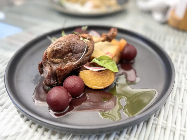 Kacze udko confit z babą ziemniaczaną, burakiem, brzoskwinią, syropem z bzu, wanilią i sosem winno-maślanym.