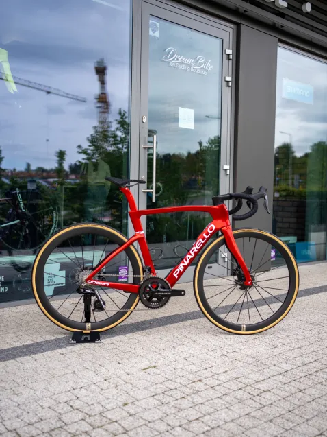 Pinarello Dogma F - Starry Red Custom - w pełni customowy rower z głębokim, czerwonym malowaniem, kołami australijskiego producenta Partington i dodatkami jak tytanowy hak przerzutki oraz carbonowe zębatki. Wartość około 100 tys. zł.