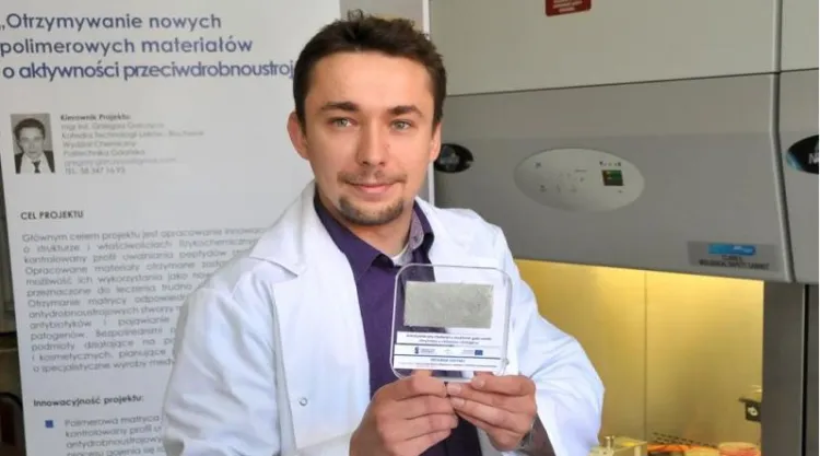 Doktorant Grzegorz Gorczyca z Politechniki Gdańskiej trzyma w ręce opracowany przez siebie innowacyjny plaster na rany zakażone gronkowcem złocistym.