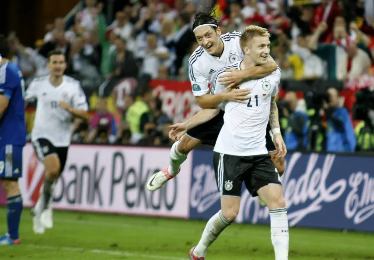 Niemcy są jak na razie na najlepszej drodze do zgarnięcia  maksymalnej puli przewidzianej dla zwycięzcy turnieju - wygrali wszystkie dotychczasowe mecze. Na zdjęciu Marco Reus i Mesut Oezil.